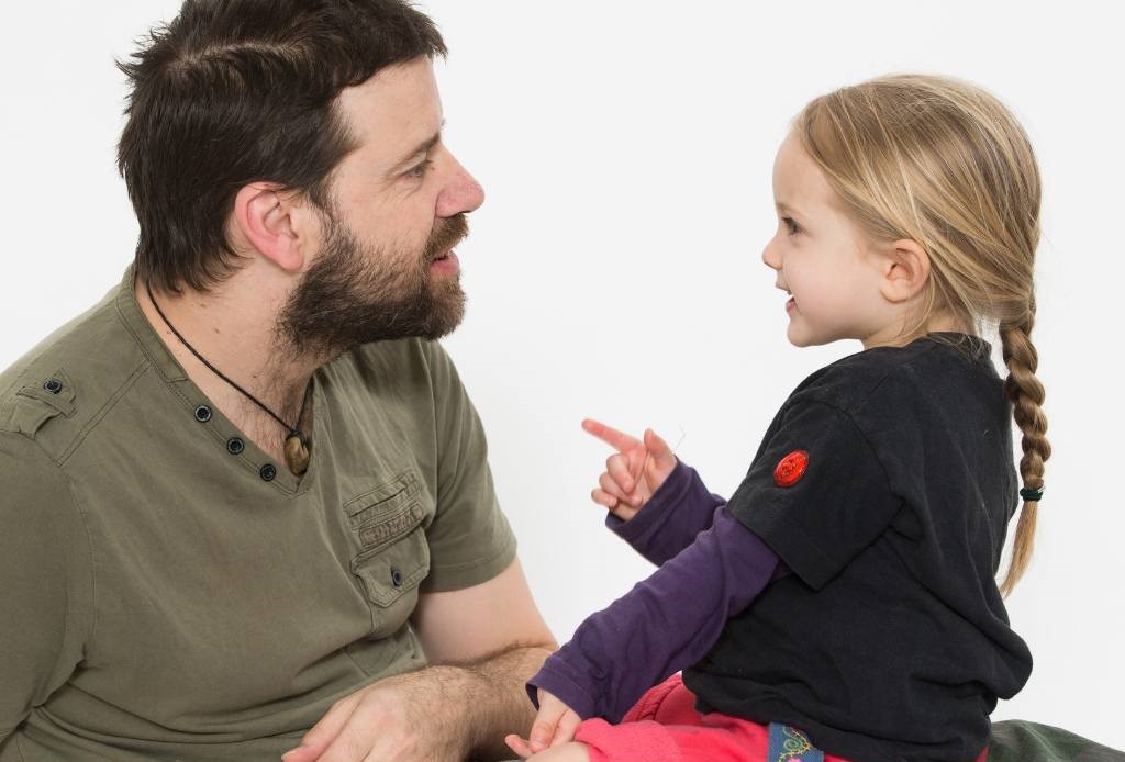 Dad and young girl chatting