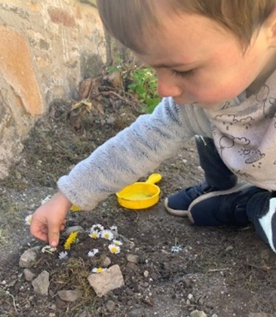 Boy playing with stones and soil (STEM)