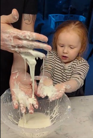 Dad and daughter playing with gloop (STEM)