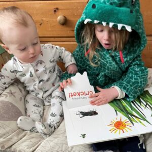 Imagination-library-siblings-reading Big sister reading Imagination Library book to baby