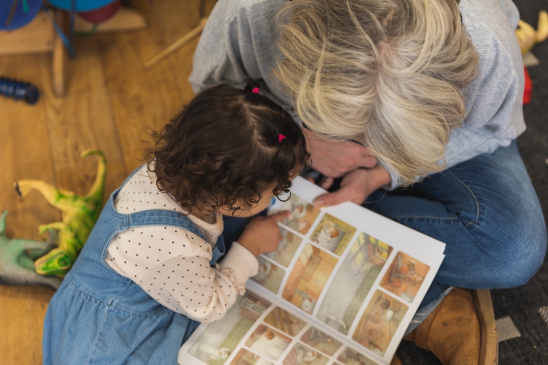 Adult and child sharing a book