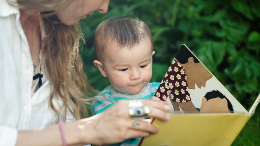 Mum reading with young child